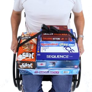 A stack of board games being secured in lap of manual wheelchair user by LapStacker